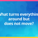 What turns everything around but does not move?